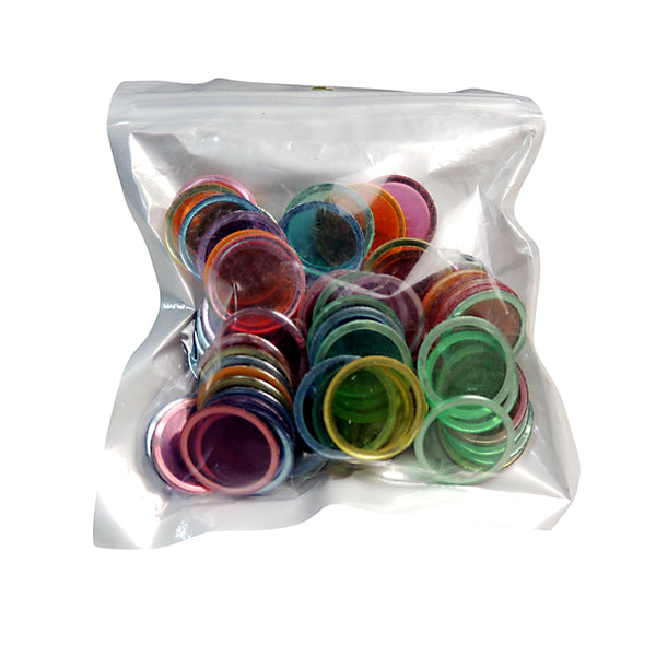 A clear plastic bag containing multicolored magnetic discs.