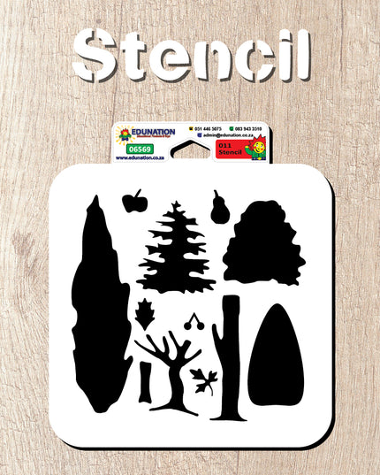A white styrene cutout stencil with various tree shapes