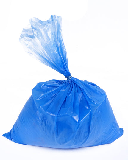 A sealed blue plastic bag against a white background, containing blue cyan paint powder.